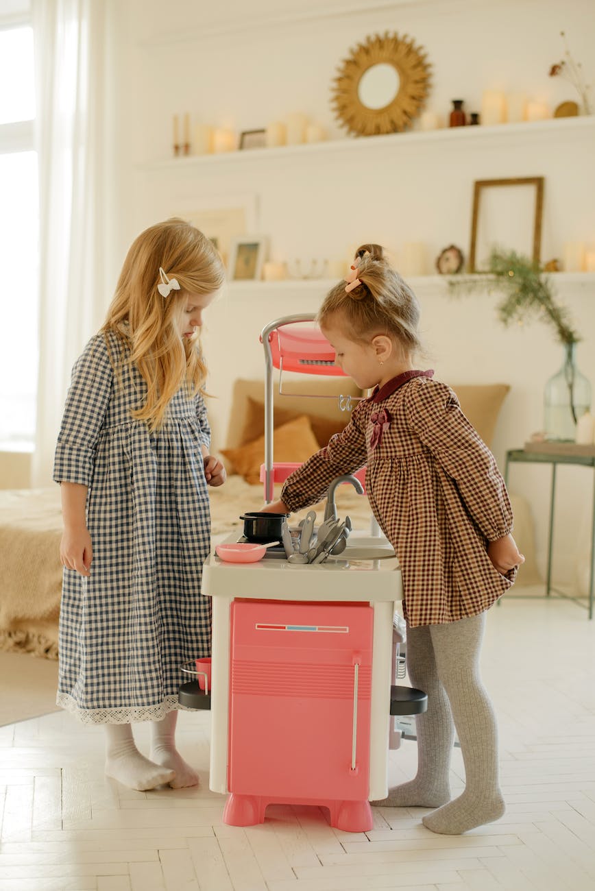 photo of kids playing with kitchen plastic toy
