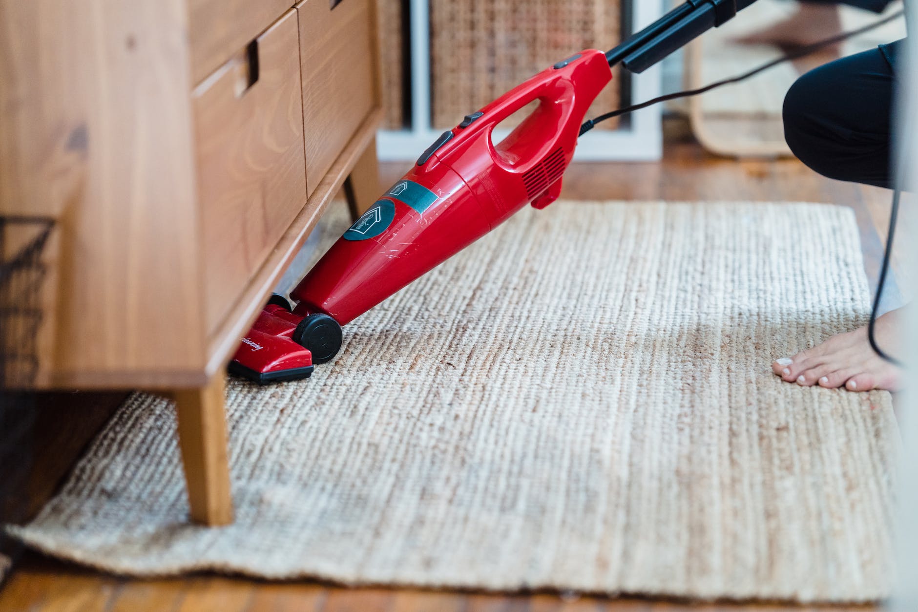 Vacuuming under a side cabinet-one cleaning task ChatGPT added to my chore list