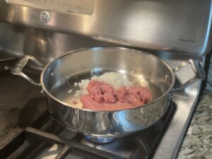 Cook the ground turkey and onions in a pan on the stove.