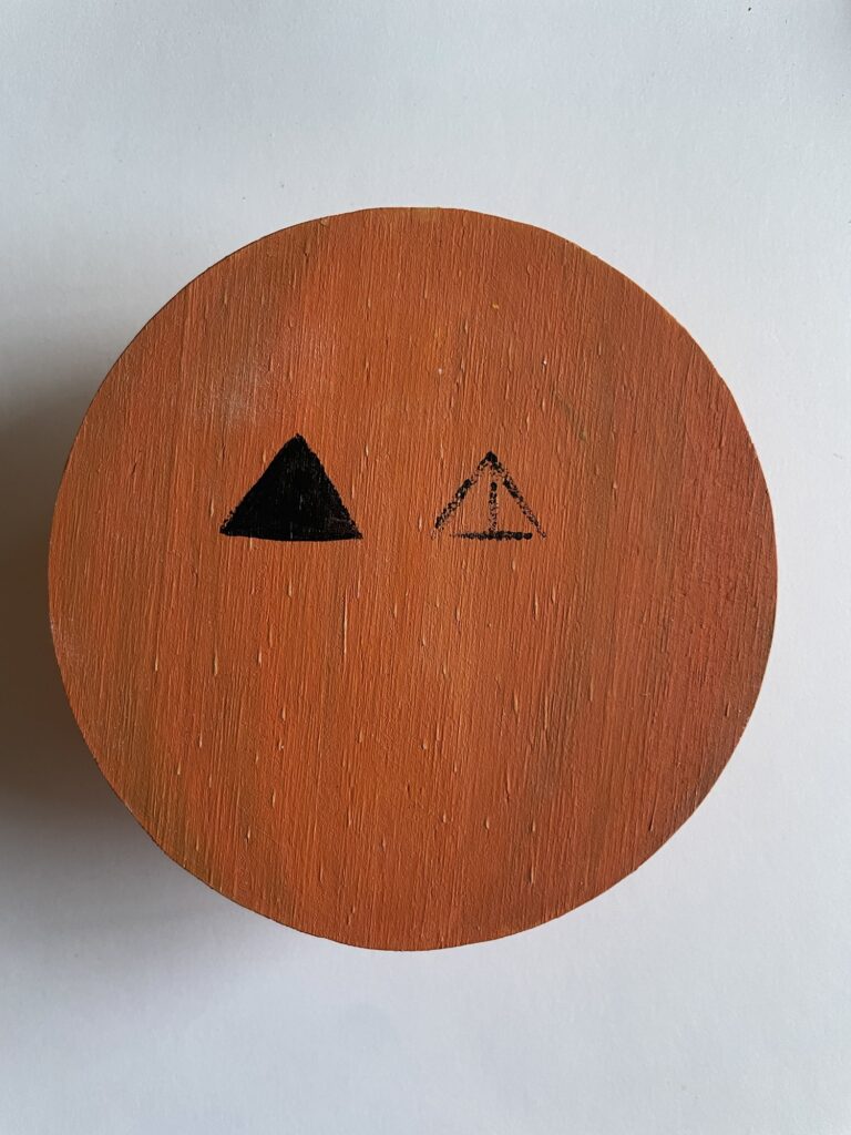 Painting the triangle pumpkin eyes. 