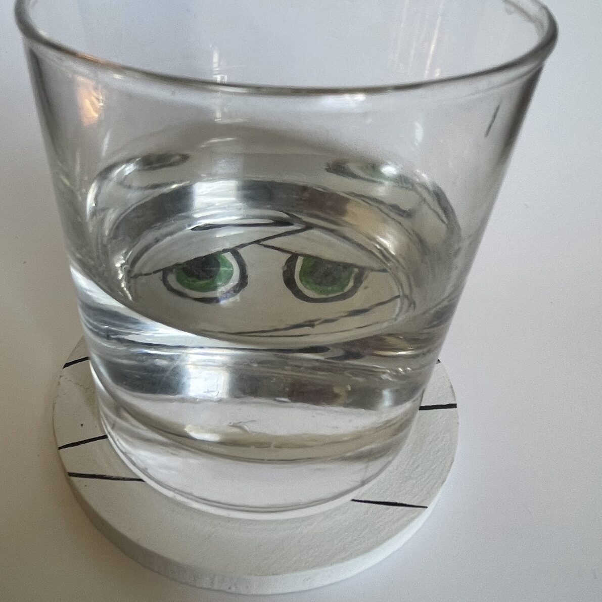 A glass on a mummy coaster. 
