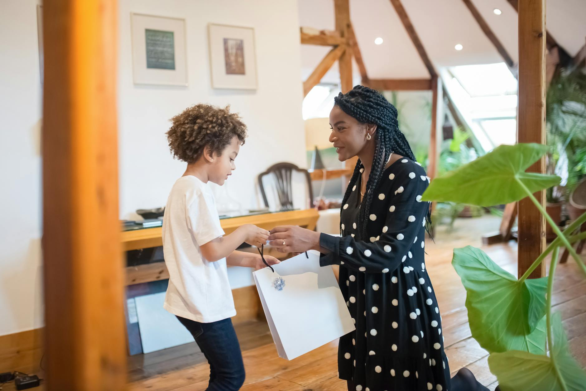 woman giving boy a gift