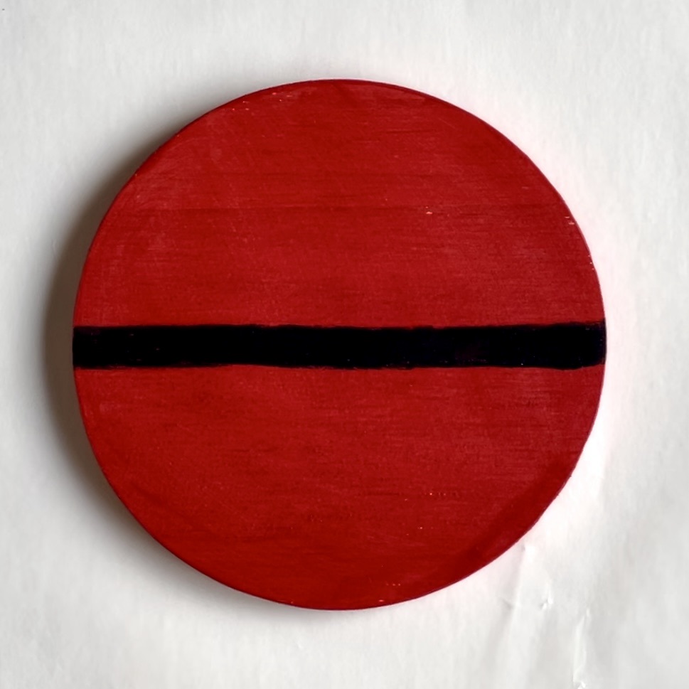 Red coaster with a black line across it.