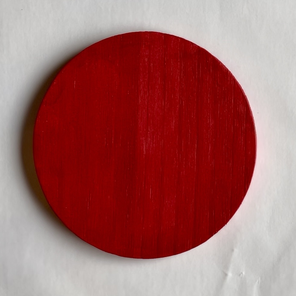 Plain red round coaster.