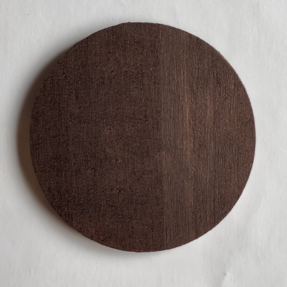 Round coaster painted brown.