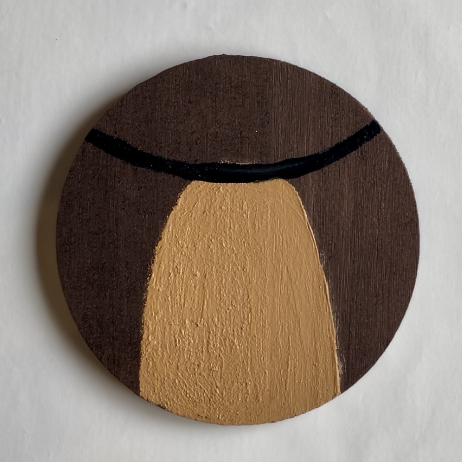 Tan oval and black curved line added to the brown coaster. 