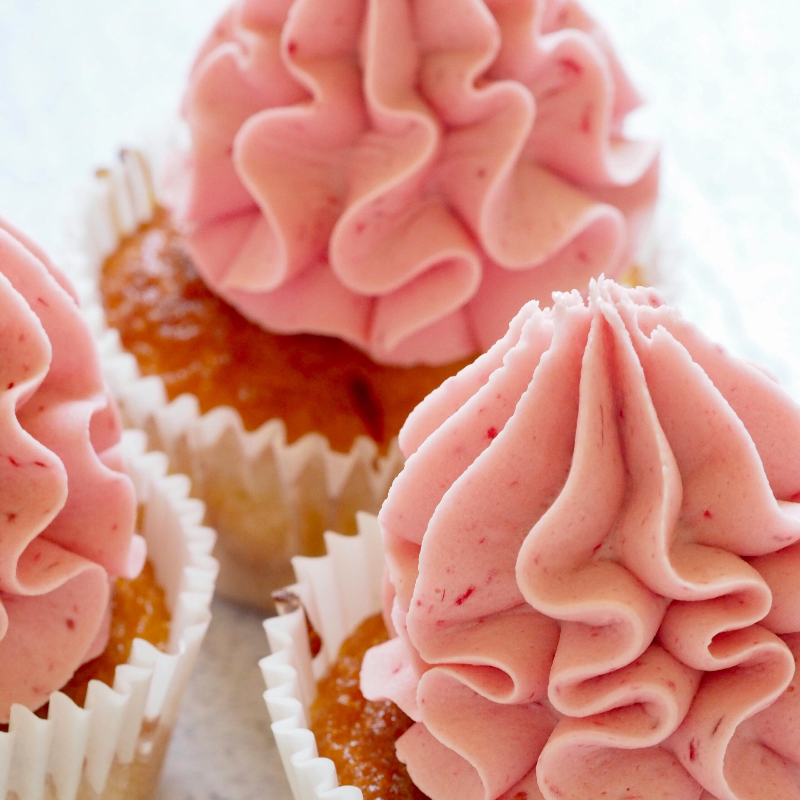 Buttercream frosting tinted and flavored with strawberries. 