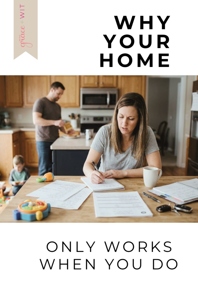 Woman sitting at kitchen table managing the household by herself.