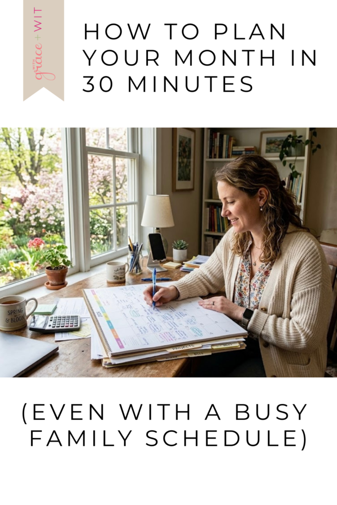 Woman planning her month, by sitting at a desk by a window and a calendar