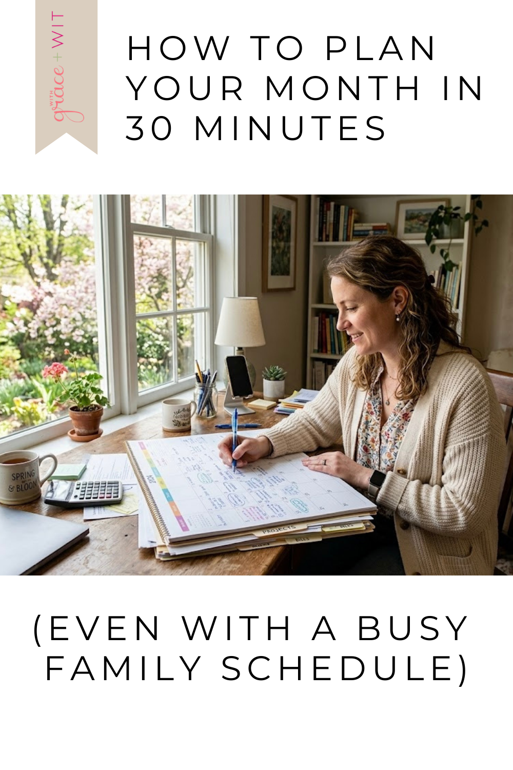 Woman planning her month, by sitting at a desk by a window and a calendar